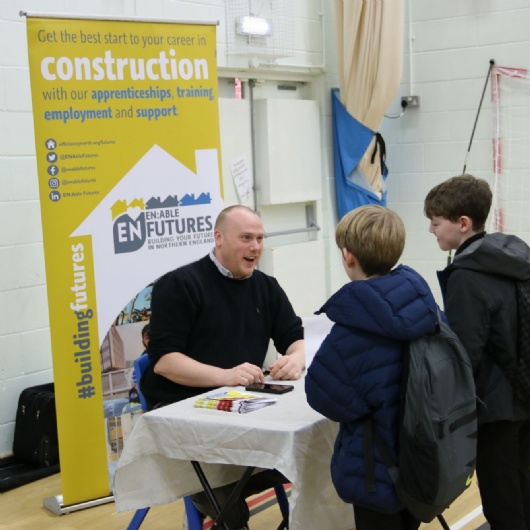students talks to an employer at the careers fair